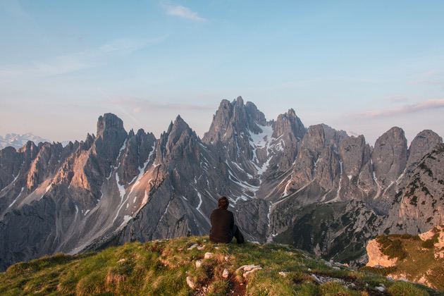 Landscape photo: Mountains and a person sitting on the edge