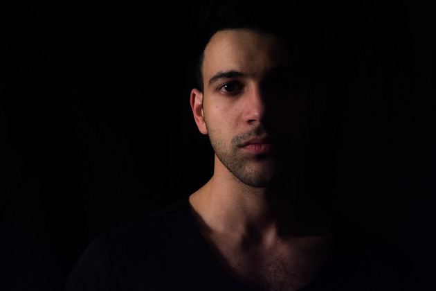 Portrait shot of a young man in the dark